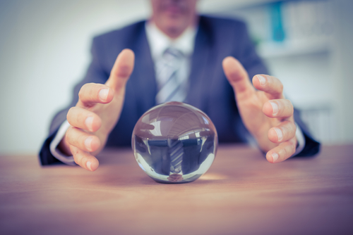 business man with crystal ball predicting Amazon costs
